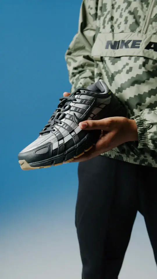A Nike shoe held to camera
