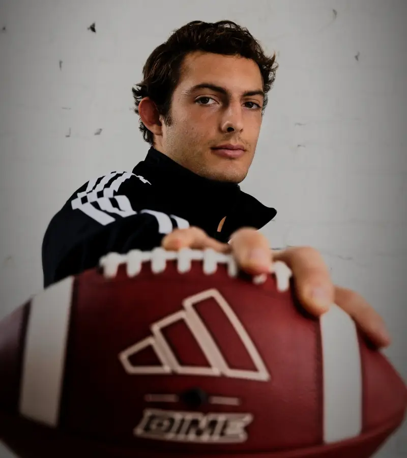 Charlie Becker holding an adidas football to the lens