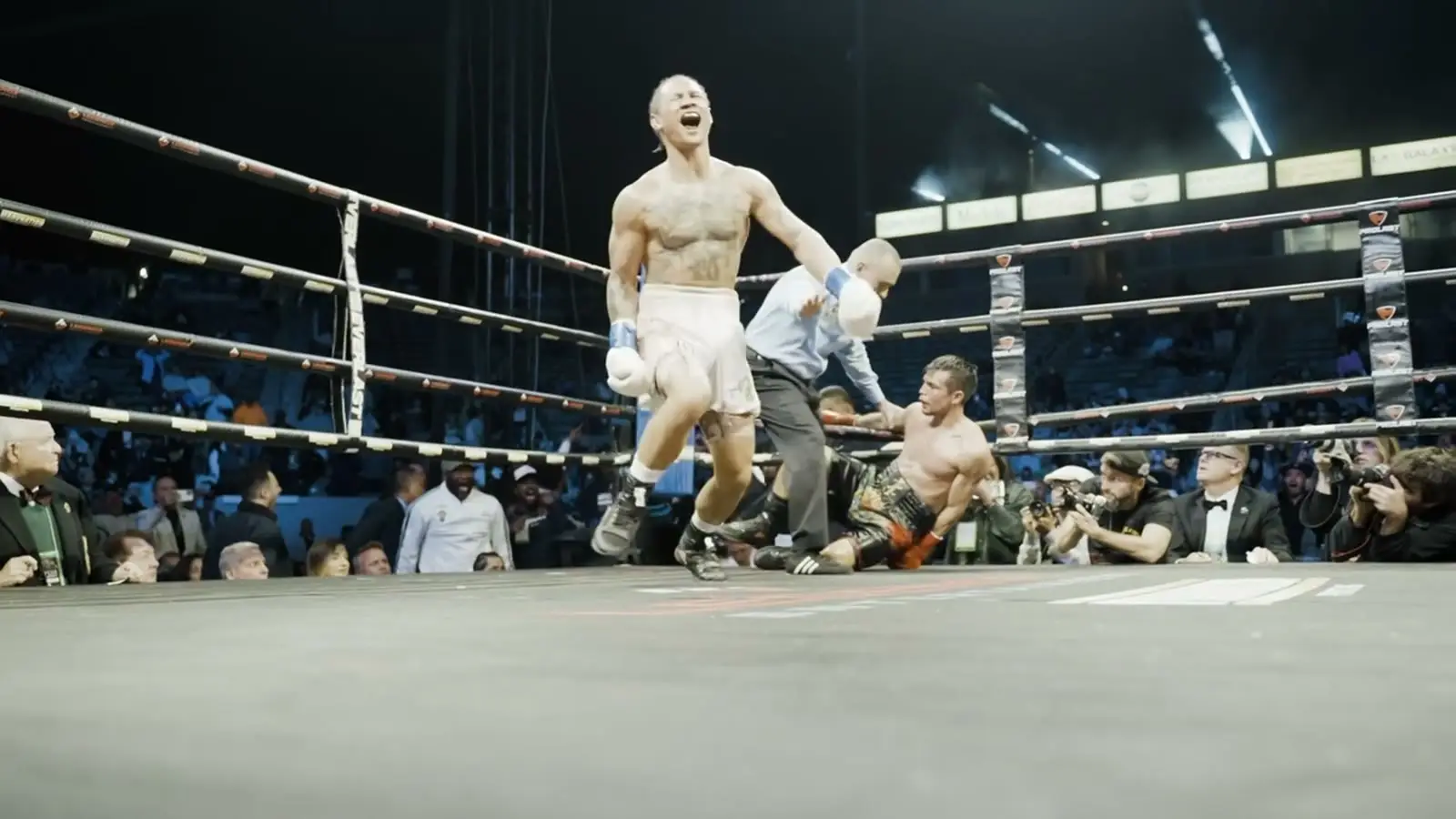 A fighter celebrating in the ring