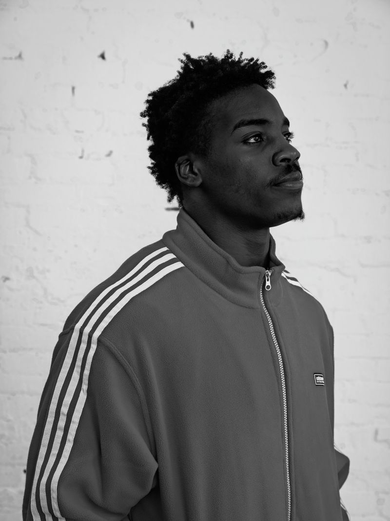 Nick Marsh in profile in an adidas track jacket, black and white
