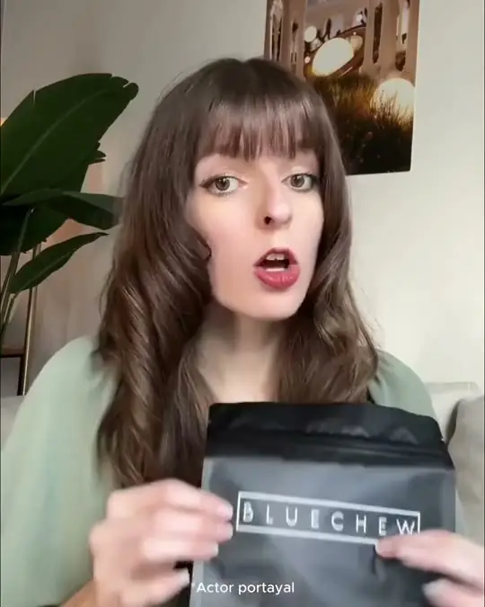 A creator holding a BlueChew pack to camera